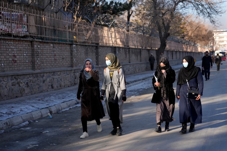 Afghan female students walk towards their university in Kabul