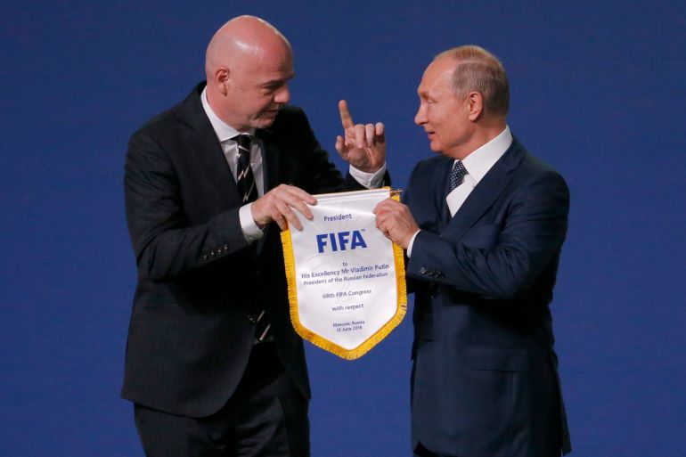 FIFA President Gianni Infantino, left, and Russian President Vladimir Putin pose for cameras