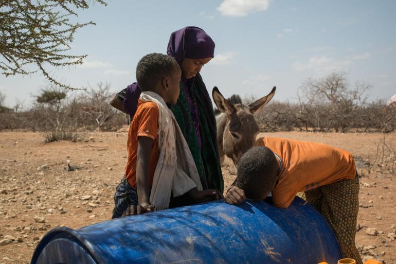 Nine-year-old Kayd looks for water with his mother Bilan and siblings in a village in Beledweyne district in southern Somalia