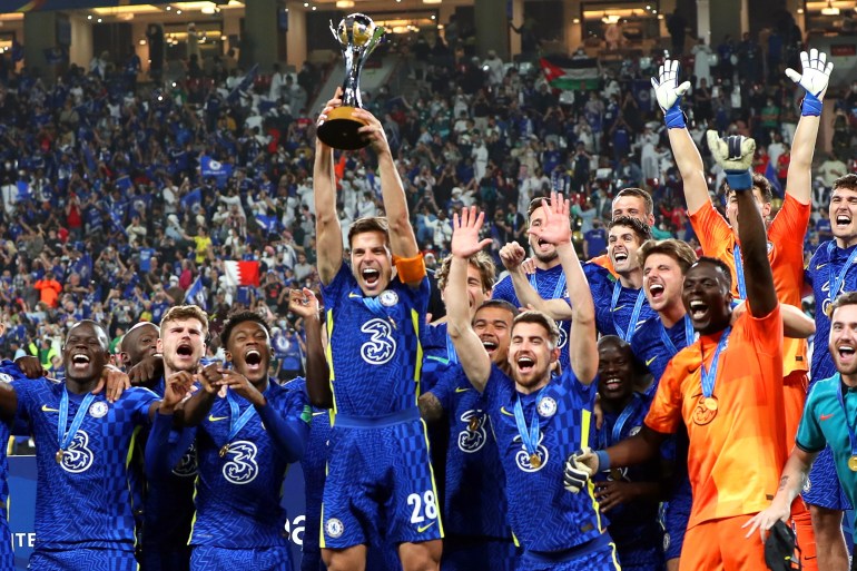 Chelsea's captain Cesar Azpilicueta (C) lifts the trophy as his teammates celebrate after winning the FIFA Club World Cup 2021