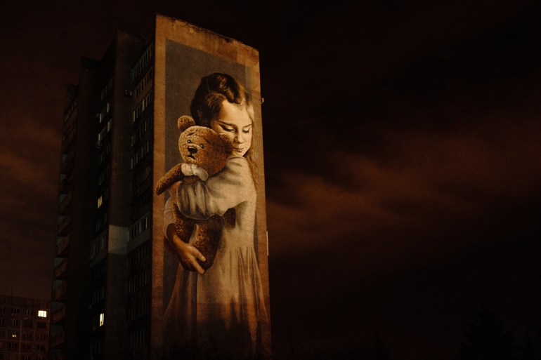 a mural of Milana, who lost her family and leg in the rocket attacks in 2014. Mariupol, Ukraine 