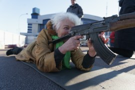 Valentyna Konstantynovska, 79, posing for a picture while training against the Russian army as a volunteer