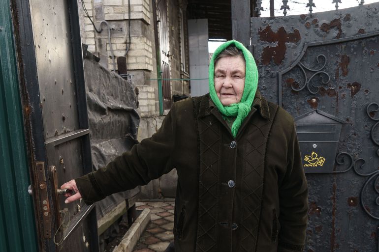 Olena Ivanivna, 65, in front of her house in Marinka, eastern Ukraine