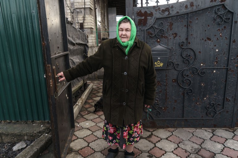 Olena Ivanivna, 65, stands in front of her house in Mariinka, eastern Ukraine