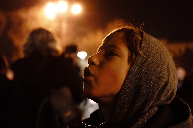 Young Ukrainian boy singing the national anthem on Feb 22, in Theater Square, Mariupol