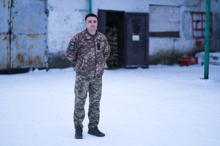 Commander Dzhemil Izmailov stands outside at an army base in eastern Ukraine