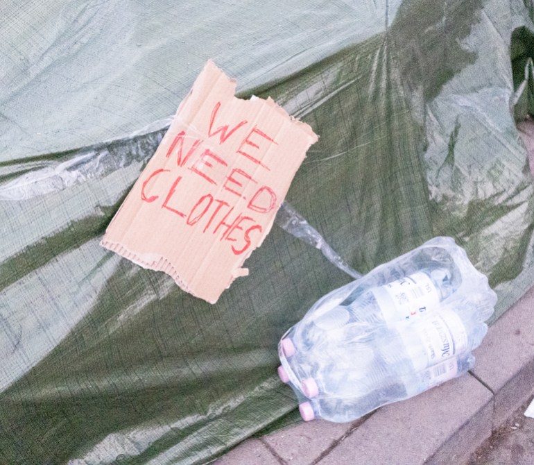 A note saying 'We need clothes', left at the Ukraine-Poland border. 