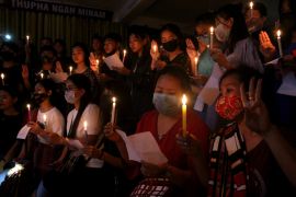 Chin refugees from Myanmar holding candles are seen during a vigil in India in memory of people killed by the junta