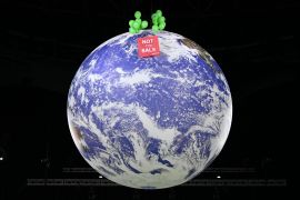 An image of planet earth is seen with a sign that reads "not for sale".