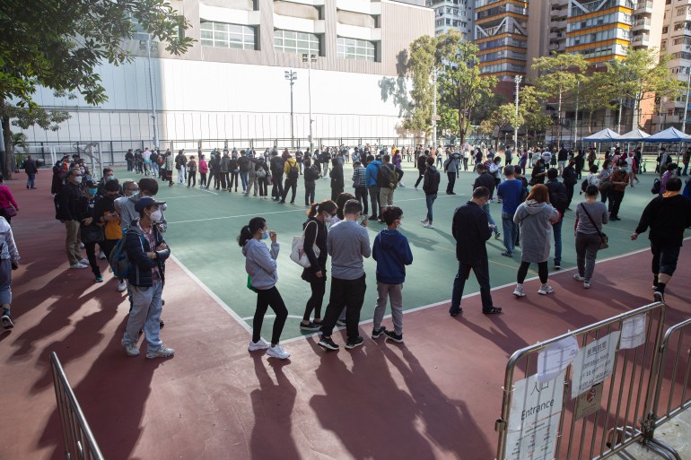 Hong Kong residents queuing for mandatory tests at a stadium in Mong Kok