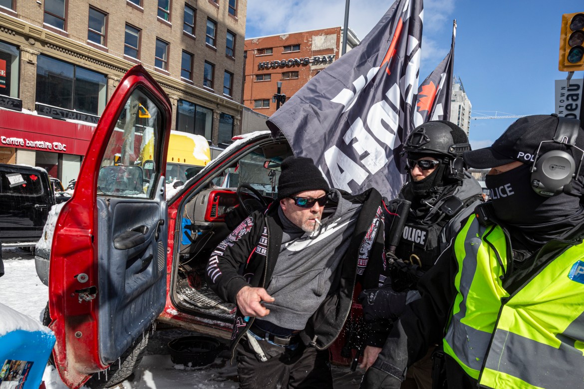 A man is removed from his vehicle by police in Ottawa, Canada