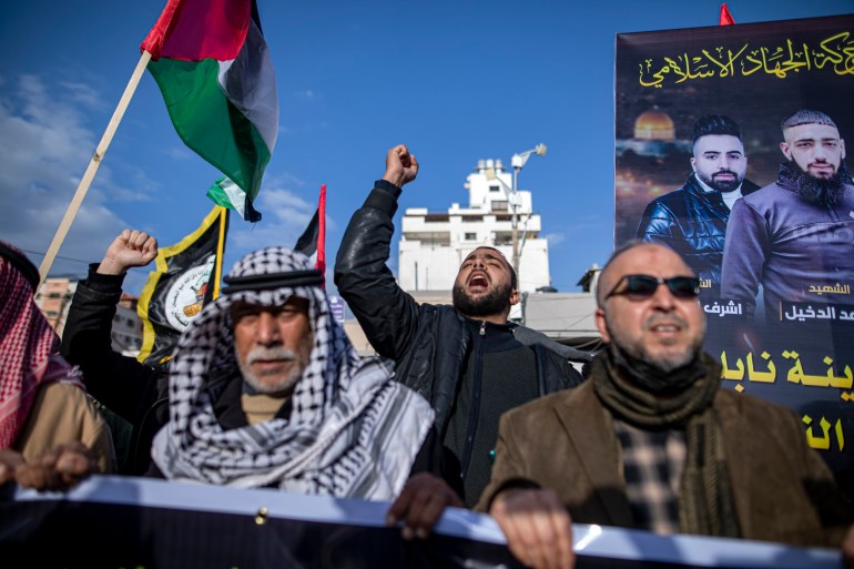 Palestinians chant slogans denouncing Israeli occupation.