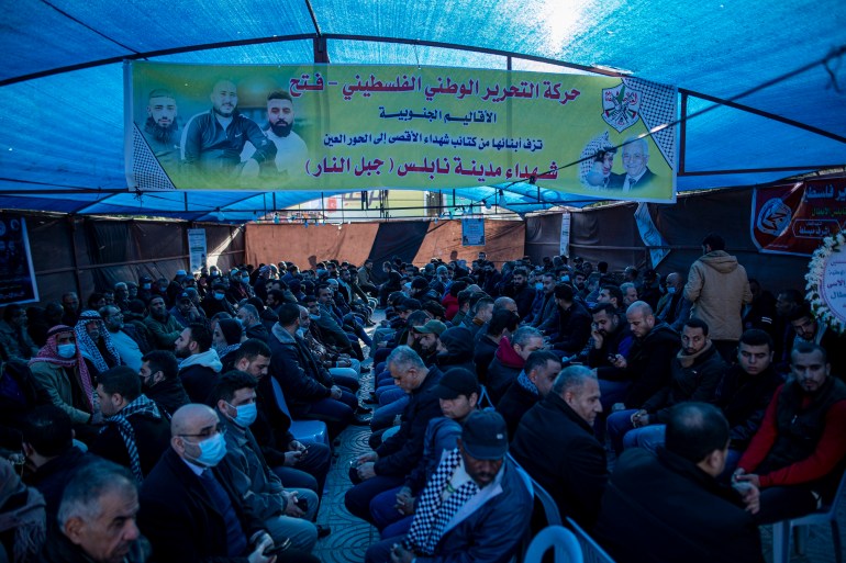 Palestinians sit a mourning tent after the march.