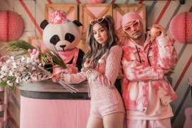 Namewee and Kimberly Chen dressed in pink with a stuffed panda from the video for Fragile.