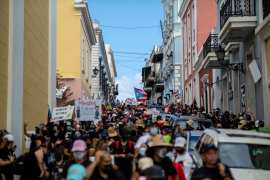 People march through the streets of Old San Juan during a teachers' protest
