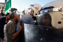A Protester argues with Palestinian riot police