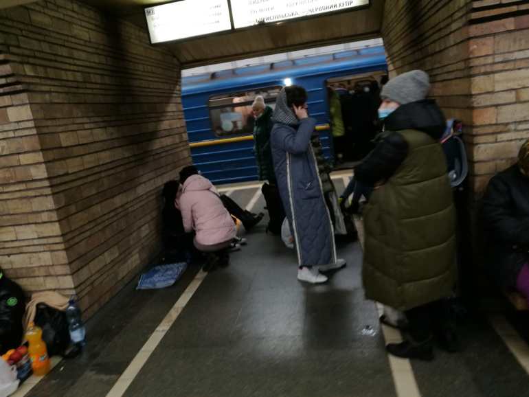 Kyiv residents are seen seeking shelter inside the city's Druzhby Narodiv metro station