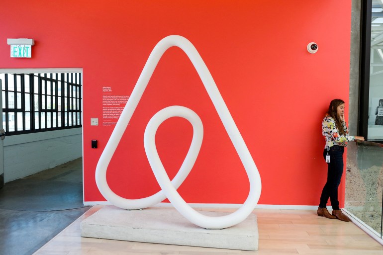 A woman talks on the phone at the Airbnb office