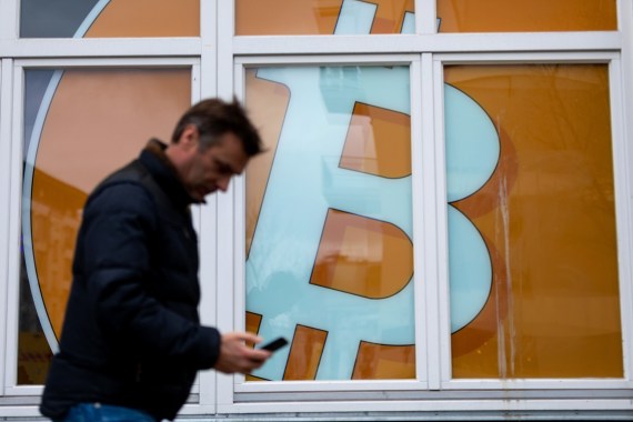 The logo of the Bitcoin cryptocurrency in a window of an office building in the Mitte district of Berlin, Germany