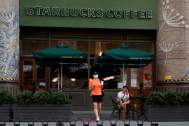 A woman leaves a cafe of Starbucks Coffee in Beijing, China