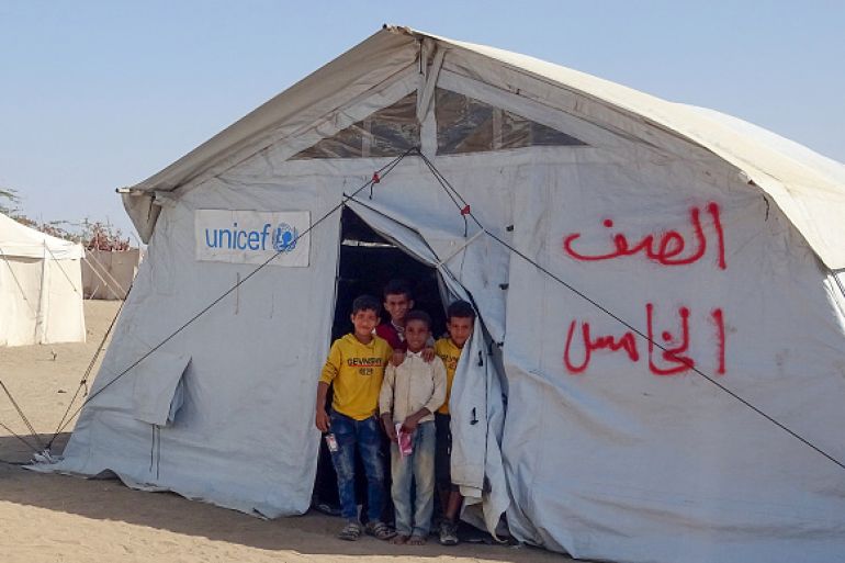 Displaced Yemeni children are pictured at the entrance of a tent used as a makeshift classroom, in the Khokha area of Yemen's war-torn western province of Hodeidah.