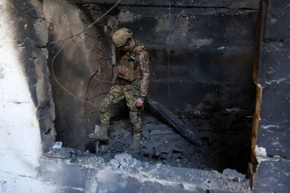 A serviceman of Ukrainian Military Forces inspects a position after a shelling on the front line with Russia.
