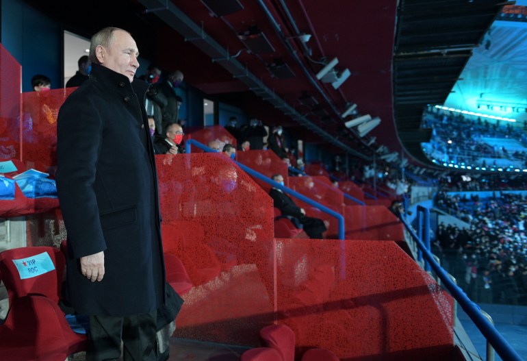 Vladimir Putin stands to attention in the Bird's Nest stadium at the opening ceremony fr the Winter Olympics