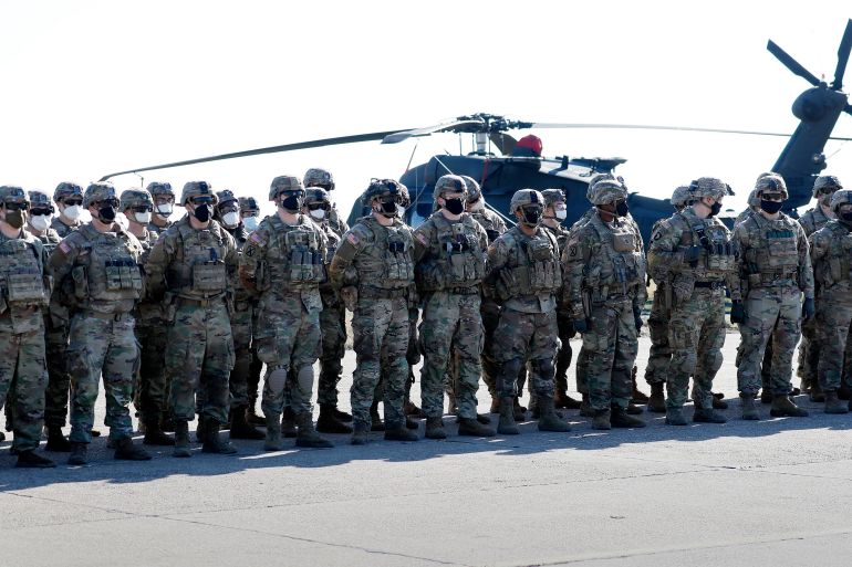 US military belonging to the Task Force Cougar detachment stand in formation for the visit of the NATO Secretary General at the military airbase of Mihail Kogalniceanu, Romania
