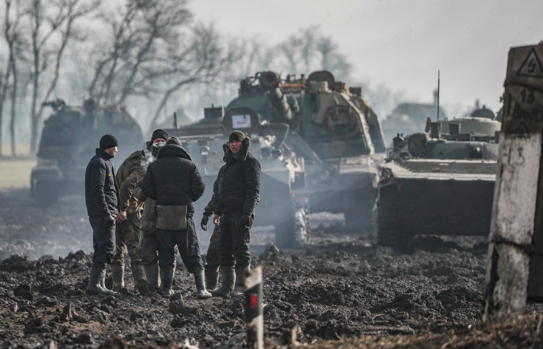 Russian servicemen and armored vehicles stand on the road in Rostov region, Russia, 22 February 2022.