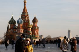 People wearing face masks walk across Red Square amid the outbreak of the coronavirus disease (COVID-19) in Moscow, Russia