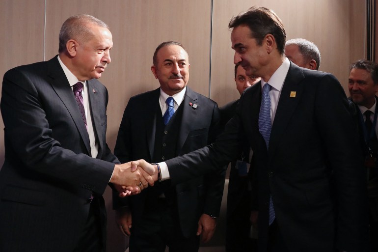 Turkey's President Recep Tayyip Erdogan shakes hands with Greek Prime Minister Kyriakos Mitsotakis