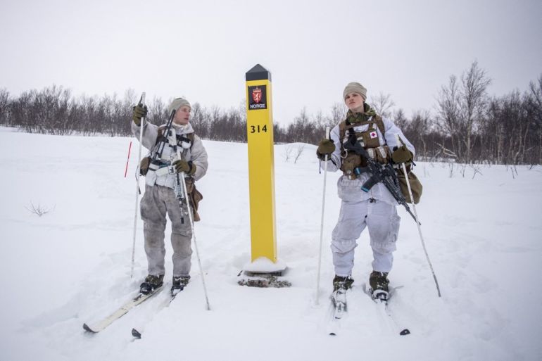 Norwegian soldiers patrol with skis on the border with Russia