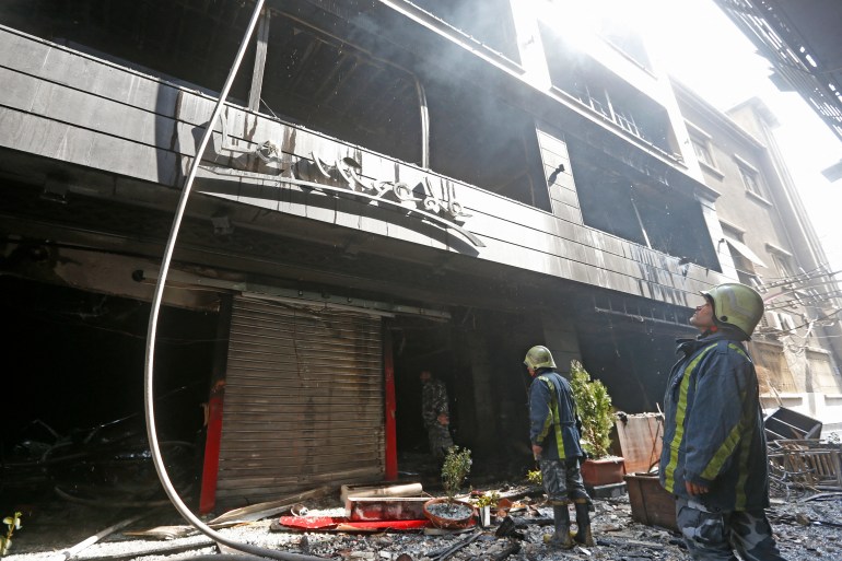 Firefighters extinguish a blaze that broke out at the La Mirada Mall in Damascus