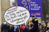 A protester holds up a sign reading &#39;My Body my choice- the right to abortion&#39; in Berlin [File: John Macdougall/AFP]