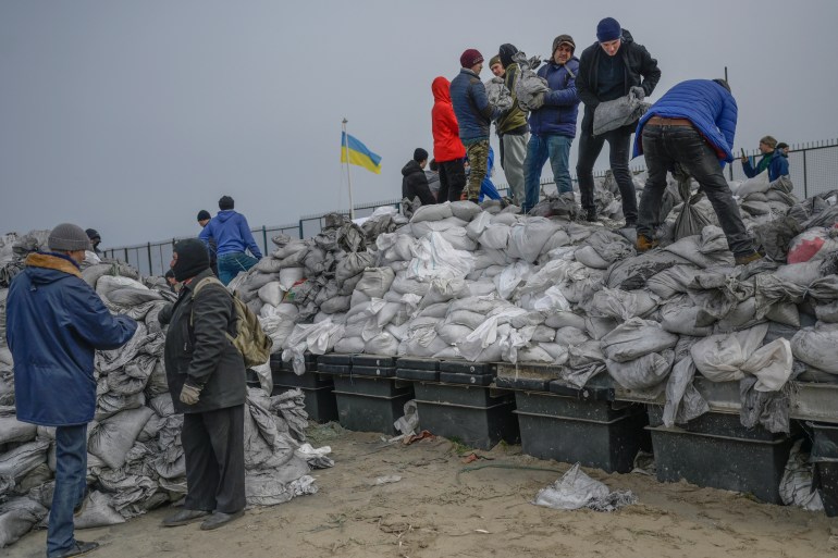 Citizens fill bags with sand for frontlines, along the beach of the Black Sea city of Odessa