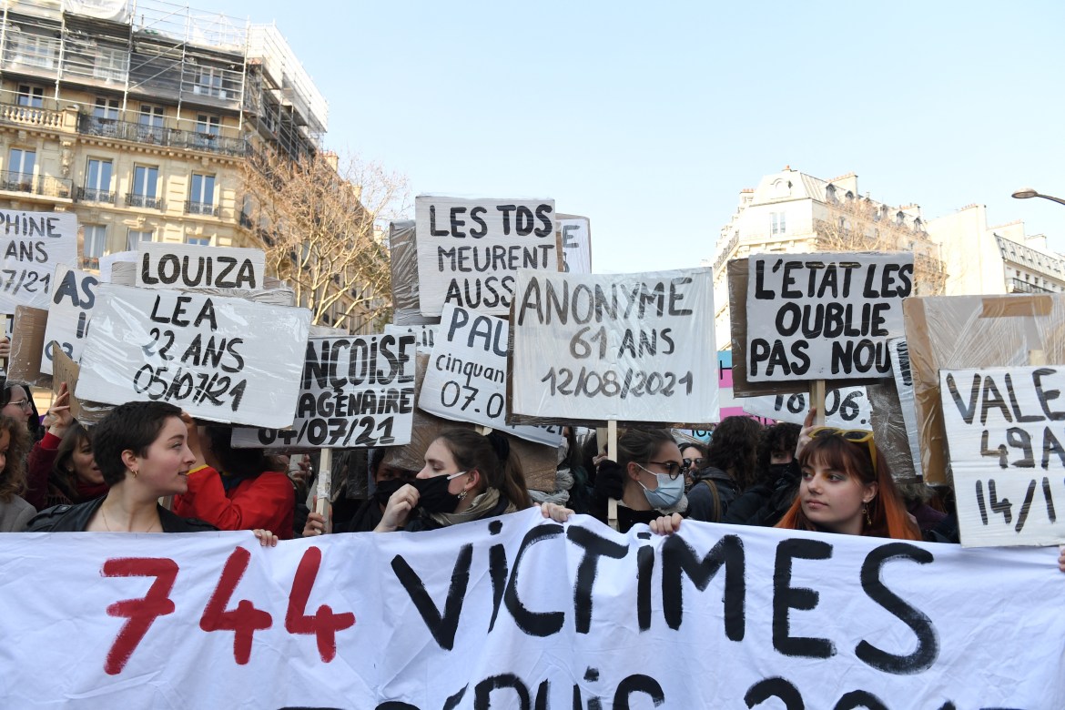 Women hold a banner and placards during a rally for gender equality and against violence towards women to mark the International Women's Day in Paris