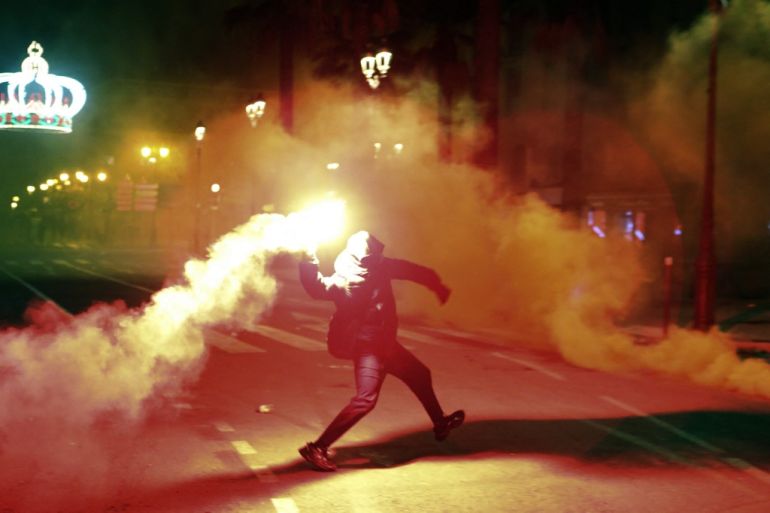 Protestors throw stones and flares in front of the prefecture in Ajaccio on France's Corsica island