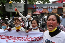 Relatives of jailed opposition members protest in front of Phnom Penh Municipal Court as the defendants were found guilty and sentenced