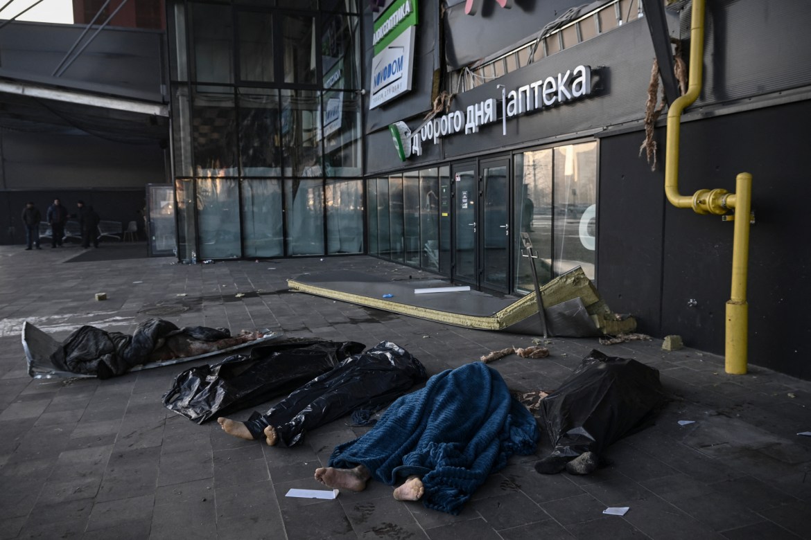 Bodies of Ukranian servicemen are covered with blankets and plastic bags outside the Retroville shopping mall