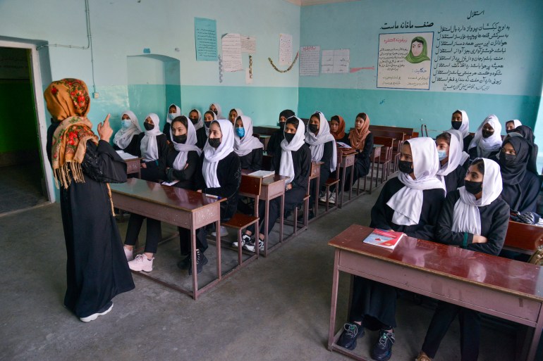 Girls attend a class after their school reopening in Kabul
