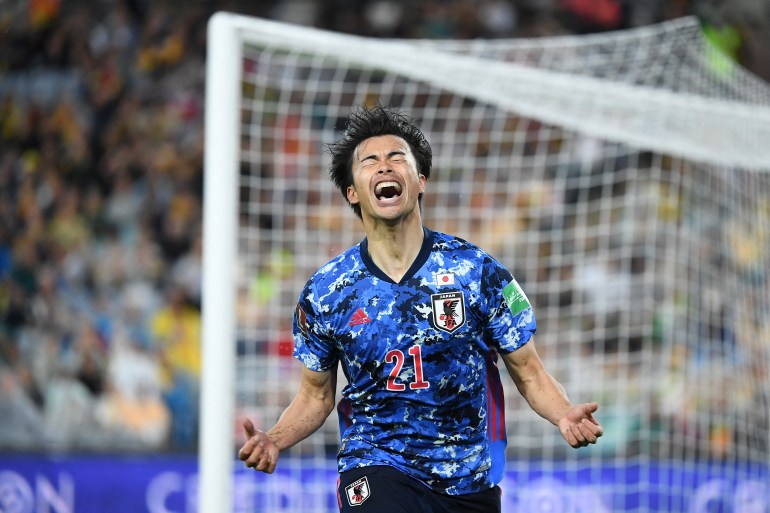 Japan's Kaoru Mitoma celebrates after scoring.