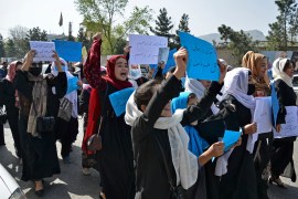 Afghan women and girls take part in a protest in front of the Ministry of Education in Kabul on March 26, 2022, demanding that high schools be reopened for girls. (File: Ahmad Sahel Arman/AFP]