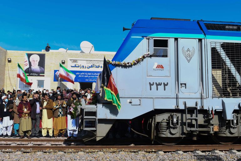 Afghan officials gather as first cargo train arrives from Iran during the official inauguration ceremony of Khaf-Herat railway network in Ghoryan district of Herat