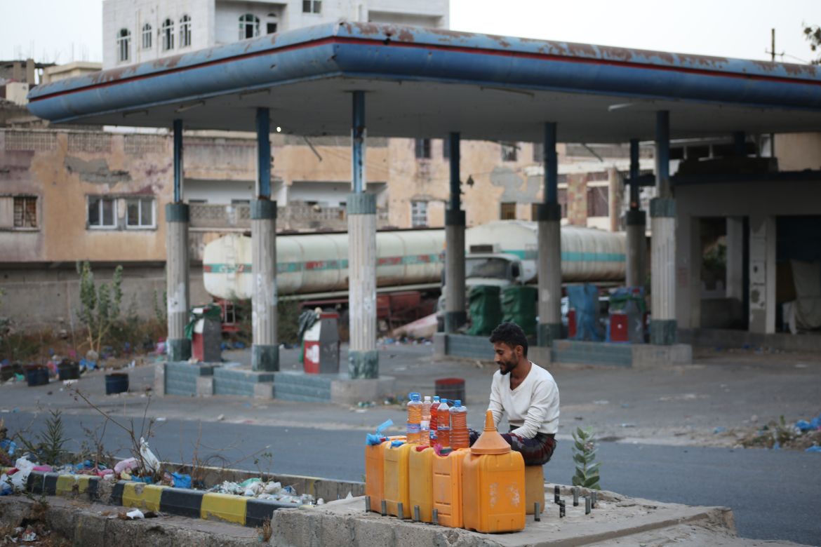 Mohammed Qaid, 20-years old, sells fuel in Taiz city near a closed petrol station