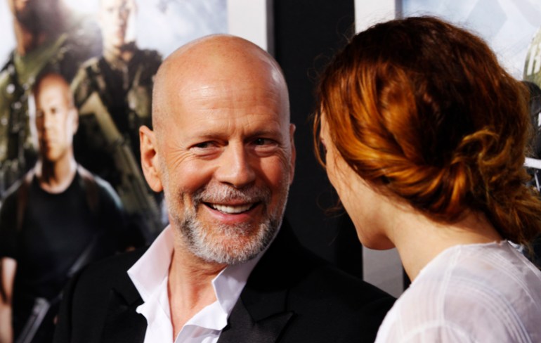 Bruce Willis smiles next to his daughter, Rumer Willis