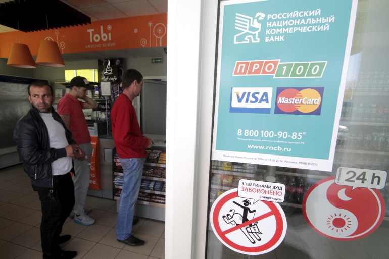 Visa and Mastercard had already announced that they were complying with US and international sanctions imposed on Russia in the wake of its attack [File: Pavel Rebrov/Reuters]