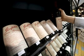 A bottle of Penfolds Grange wine is selected at a Sydney boutique wine store