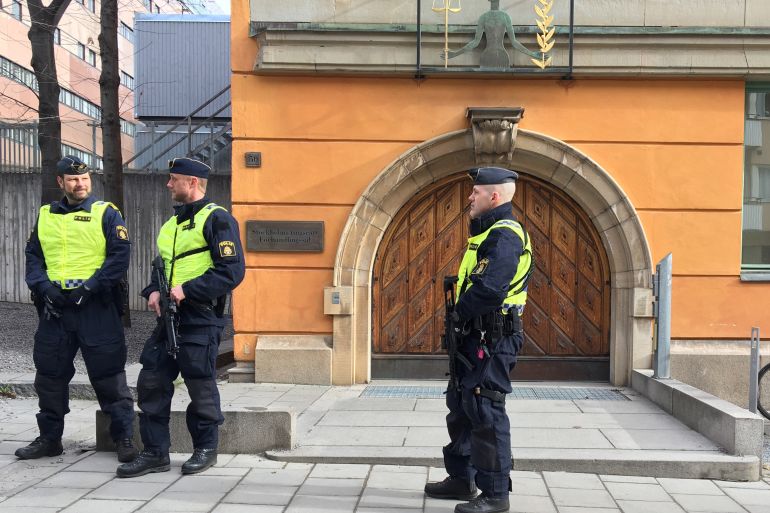 Police stand at Stockholm's district court building
