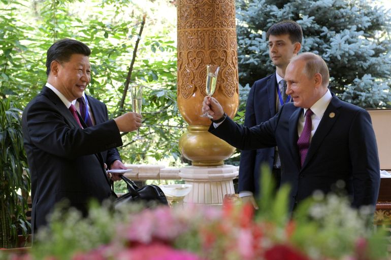 Russian President Vladimir Putin (R) toasts with Chinese President Xi Jinping while congratulating him on his birthday before the Conference on Interaction and Confidence-Building Measures in Asia (CICA) in Dushanbe, Tajikistan June 15, 2019.