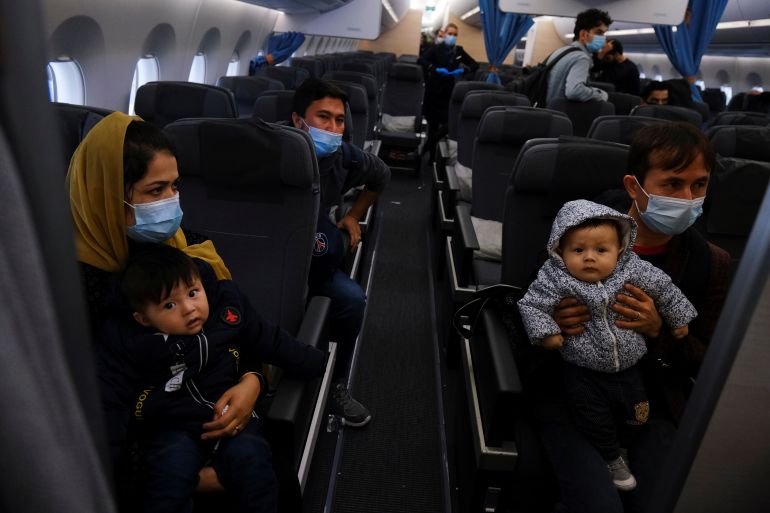Afghans that fled Kabul are seen inside an airplane